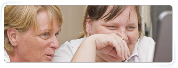 About Us banner - 2 women using a computer